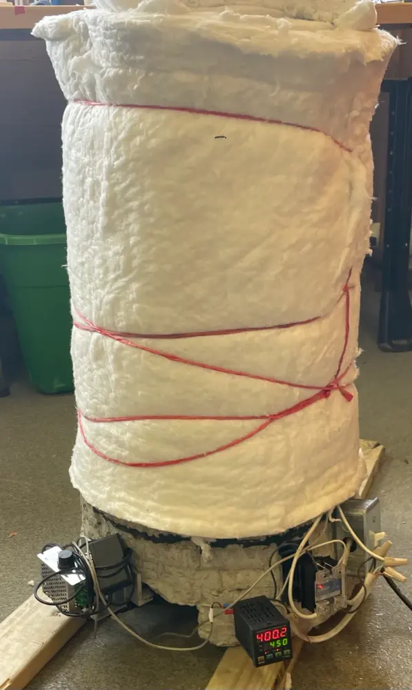 Cylinder wrapped in ceramic insulation, temperature controller reading 400 °C