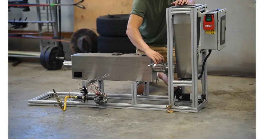 SequesChar Generation 02 prototype — stainless reactor on extruded aluminum frame with HMI and start/stop controls